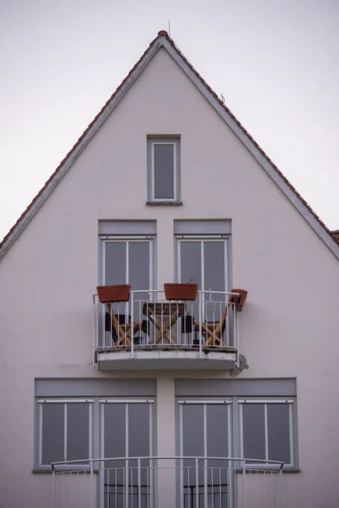 A pair of chairs and table on a balcony in Ulm, Germany, 2023.