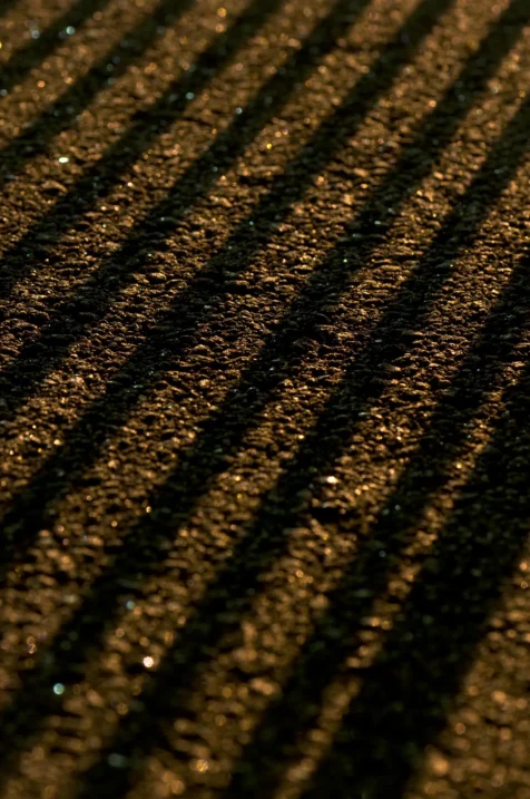 Diagonal shadows on asphalt at night in Valley Cottage, New York, 2013.