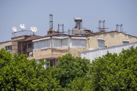 Satellite dishes and antennas on apartment rooftops in Antalya, Turkey, 2023.