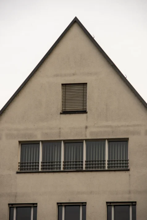 A tan building with many windows in Ulm, Germany, 2023.