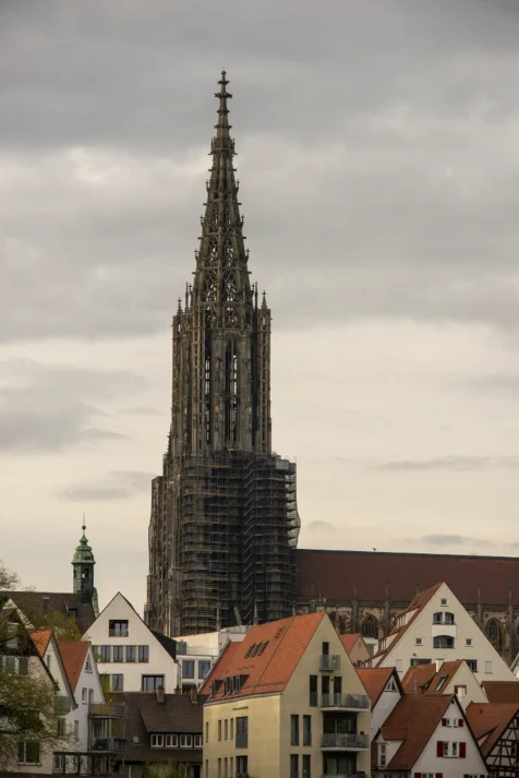 The Ulmer Munster Cathedral and surrounding buildings on a cloudy afternoon in Ulm, Germany, 2023.