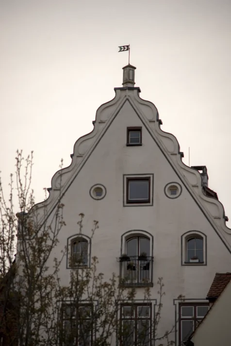 A unique white building and tree at dusk in Ulm, Germany, 2023.