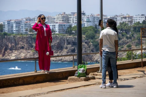 A woman has her picture taken near the sea in Antalya, Turkey, 2023.