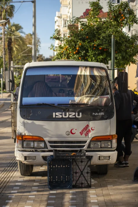An old Isuzu delivery truck on the sidewalk in Antalya, Turkey, 2024.