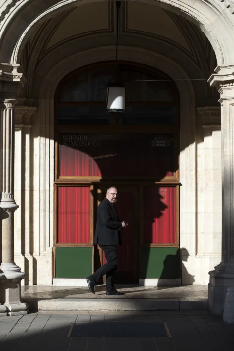 A man walking near a door in Vienna, Austria, 2023.