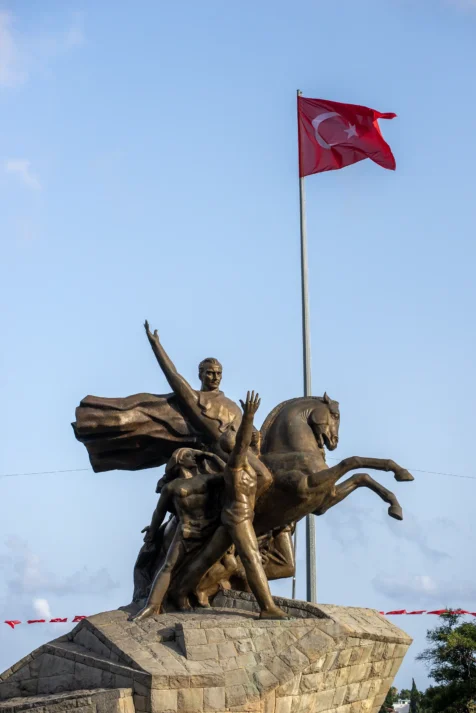 A statue and Turkish flag in downtown Antalya, Turkey, 2024.