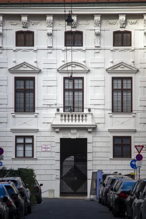 A white building and parked cars in Vienna, Austria, 2023.