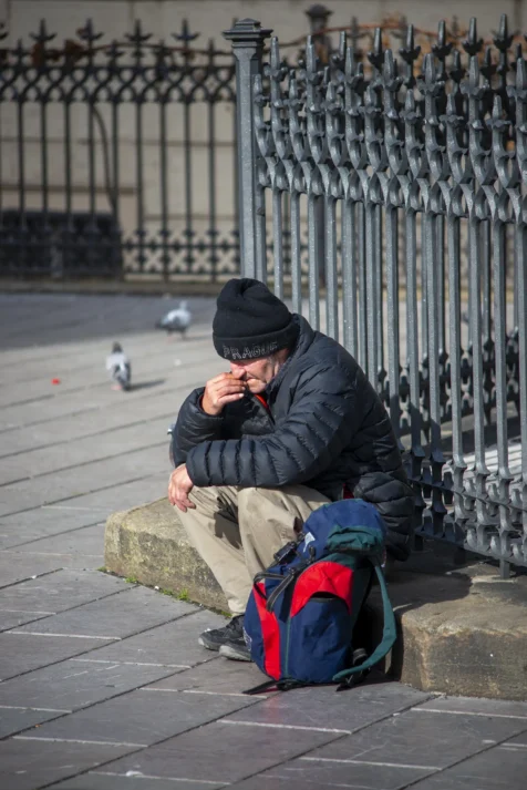 A man smoking a cigarette near Charles Bridge in Prague, Czech Republic.