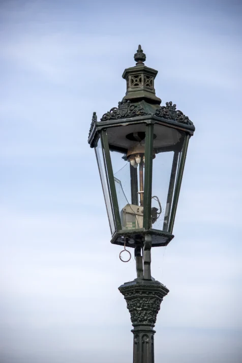 A streetlight with broken glass on Charles Bridge in Prague, Czech Republic.